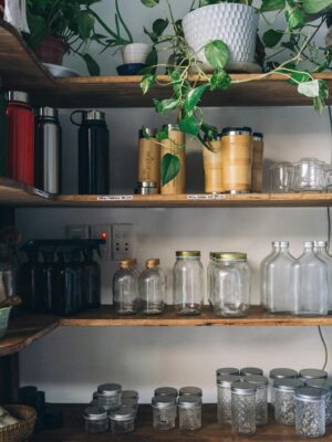 Glass Bottles and Containers on a Wooden Shelf