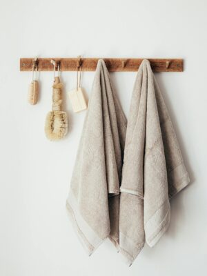 Wooden hanger with towels and natural bathroom tools